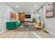 Modern living room with stylish decor, a plush green sofa, and eye-catching abstract artwork at 3408 Phillips Cir, Decatur, GA 30032