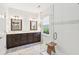 This bathroom boasts a double vanity and a glass shower with a small wooden seat at 3804 Tattenhall Drive Dr, Cumming, GA 30040