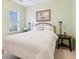 Cozy bedroom with a neatly made bed, neutral colored walls and a window with natural light at 3804 Tattenhall Drive Dr, Cumming, GA 30040