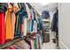Well-organized walk-in closet with clothes and accessories racked and shelved on all sides at 3804 Tattenhall Drive Dr, Cumming, GA 30040