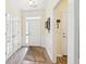 Bright foyer featuring hardwood floors, elegant wainscoting, and a glass paneled door at 3804 Tattenhall Drive Dr, Cumming, GA 30040