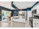 This kitchen opens to dining and sunroom areas with stainless appliances and granite countertops at 3804 Tattenhall Drive Dr, Cumming, GA 30040