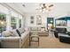 Bright living room features a large sectional sofa, ceiling fan and large windows at 3804 Tattenhall Drive Dr, Cumming, GA 30040