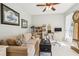 Comfortable living room featuring a beige sofa, desk, and natural light at 3804 Tattenhall Drive Dr, Cumming, GA 30040