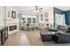 Cozy living room with a fireplace, ceiling fan, and a comfortable sectional sofa at 3804 Tattenhall Drive Dr, Cumming, GA 30040