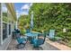 Outdoor patio with a table and chairs and lush landscaping at 3804 Tattenhall Drive Dr, Cumming, GA 30040