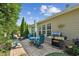 Outdoor patio with a table and chairs, grill, and lush landscaping at 3804 Tattenhall Drive Dr, Cumming, GA 30040