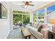 Relaxing sunroom with ample natural light, comfortable seating, and tiled floors at 3804 Tattenhall Drive Dr, Cumming, GA 30040