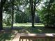 Expansive backyard with mature trees, providing shade and privacy in this lovely outdoor space at 21 Queen Anne Se Dr, Mableton, GA 30126