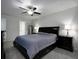 Comfortable bedroom with a ceiling fan, neutral walls and carpet. The room is furnished with a black bed set at 21 Queen Anne Se Dr, Mableton, GA 30126