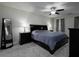 Cozy bedroom with a ceiling fan, and gray carpet. The room is furnished with a black bed set at 21 Queen Anne Se Dr, Mableton, GA 30126