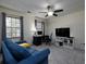Cozy bedroom features a comfortable couch, ceiling fan and a dedicated workspace, offering comfort and functionality at 21 Queen Anne Se Dr, Mableton, GA 30126