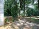 Wooden deck surrounded by lush greenery and mature trees, perfect for enjoying the outdoors at 21 Queen Anne Se Dr, Mableton, GA 30126