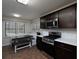 Traditional kitchen with a dining nook featuring a built-in bench, stainless steel appliances and dark cabinets at 21 Queen Anne Se Dr, Mableton, GA 30126