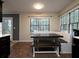 Dining area with built-in bench seating and large windows, plus an exterior door with glass panes at 21 Queen Anne Se Dr, Mableton, GA 30126