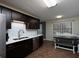Dark-wood kitchen with stainless appliances and white marble backsplash, plus a dining nook with a built-in bench at 21 Queen Anne Se Dr, Mableton, GA 30126