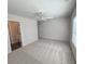Spacious bedroom with plush carpet, ceiling fan, and natural light from a large window at 5447 Blossomwood Sw Trl, Mableton, GA 30126
