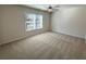 Bright bedroom with large window and plush carpeting, providing a comfortable space at 5447 Blossomwood Sw Trl, Mableton, GA 30126
