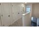 Hallway with carpet, access to a bathroom, bedroom, and view of the staircase at 5447 Blossomwood Sw Trl, Mableton, GA 30126