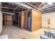 Unfinished basement with exposed utilities, concrete floor, and doorway at 1180 Springs Dr, Canton, GA 30115