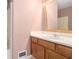 Bathroom featuring a wood vanity, a large mirror, and a shower with a partial glass enclosure at 1180 Springs Dr, Canton, GA 30115