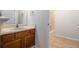 Hall bathroom includes a vanity with oak cabinets, ceramic sink, and a tub-shower combo at 1180 Springs Dr, Canton, GA 30115