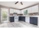 Updated kitchen features ample counter space, tile backsplash, and access to a backyard deck at 1180 Springs Dr, Canton, GA 30115