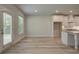 Spacious open concept area with white cabinets, stainless appliances, and a door leading to the outside at 141 Compass Rd, Hampton, GA 30228