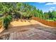 View of a partially fenced backyard with trees and greenery at 2859 Woodward Down Trl, Buford, GA 30519