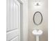 Bathroom featuring pedestal sink, oval mirror and modern lighting at 2859 Woodward Down Trl, Buford, GA 30519