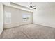 Bright bedroom features a ceiling fan, windows, and plush carpeting at 2859 Woodward Down Trl, Buford, GA 30519