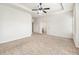 Expansive bedroom featuring carpeted floors, a ceiling fan, and white walls at 2859 Woodward Down Trl, Buford, GA 30519