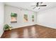 Bright bedroom with hardwood floors, neutral walls, and ample natural light from multiple windows with backyard views at 2859 Woodward Down Trl, Buford, GA 30519