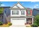 Charming two-story home with a well-maintained lawn, attached garage and inviting curb appeal on a sunny day at 2859 Woodward Down Trl, Buford, GA 30519