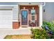Cozy front porch with decorative chairs, brick accents, and a charming garden for a welcoming entryway at 2859 Woodward Down Trl, Buford, GA 30519