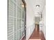 Bright hallway featuring hardwood floors, white trim, and a glass front door, leading into the living area at 2859 Woodward Down Trl, Buford, GA 30519