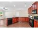 Well-equipped kitchen featuring dark cabinetry, granite countertops, stainless steel appliances, and hardwood floors throughout at 2859 Woodward Down Trl, Buford, GA 30519