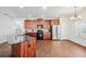Modern kitchen with dark wood cabinetry, stainless steel appliances, granite counters, and breakfast nook with natural light at 2859 Woodward Down Trl, Buford, GA 30519