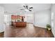 Open-concept living area featuring hardwood floors, a ceiling fan, and seamless flow to the modern kitchen at 2859 Woodward Down Trl, Buford, GA 30519