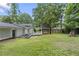 Backyard features a deck, picnic table, and charming playhouse surrounded by lush greenery at 431 Hickory Se Ln, Smyrna, GA 30082