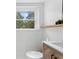 Bathroom features tile flooring and walls, a storage shelf and a window with natural light at 431 Hickory Se Ln, Smyrna, GA 30082