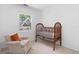 Bedroom with crib, chair, and carpeted floors at 431 Hickory Se Ln, Smyrna, GA 30082