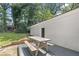 Outdoor deck with a picnic table surrounded by trees offers an ideal space for backyard gatherings at 431 Hickory Se Ln, Smyrna, GA 30082