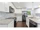 Modern kitchen with stainless steel appliances, granite countertops, and white cabinets at 431 Hickory Se Ln, Smyrna, GA 30082