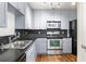 Updated kitchen features stainless steel appliances, double sink, dark countertops and light gray cabinets at 230 E Ponce De Leon Ave # 104, Decatur, GA 30030