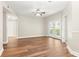 Bright living room with hardwood floors, ceiling fan, and french doors leading to a balcony at 230 E Ponce De Leon Ave # 104, Decatur, GA 30030