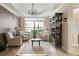 Comfortable lounge area featuring three armchairs, a coffee table, and a bookshelf bathed in natural light from a large window at 230 E Ponce De Leon Ave # 104, Decatur, GA 30030