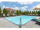 Community pool with chaise lounge seating and landscaping at 230 E Ponce De Leon Ave # 104, Decatur, GA 30030