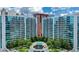 Stunning aerial view of the building and pool, surrounded by lush greenery and city skyline at 950 W Peachtree Nw St # 812, Atlanta, GA 30309