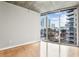 Bright bedroom featuring hardwood floors and floor-to-ceiling windows with cityscape views at 950 W Peachtree Nw St # 812, Atlanta, GA 30309